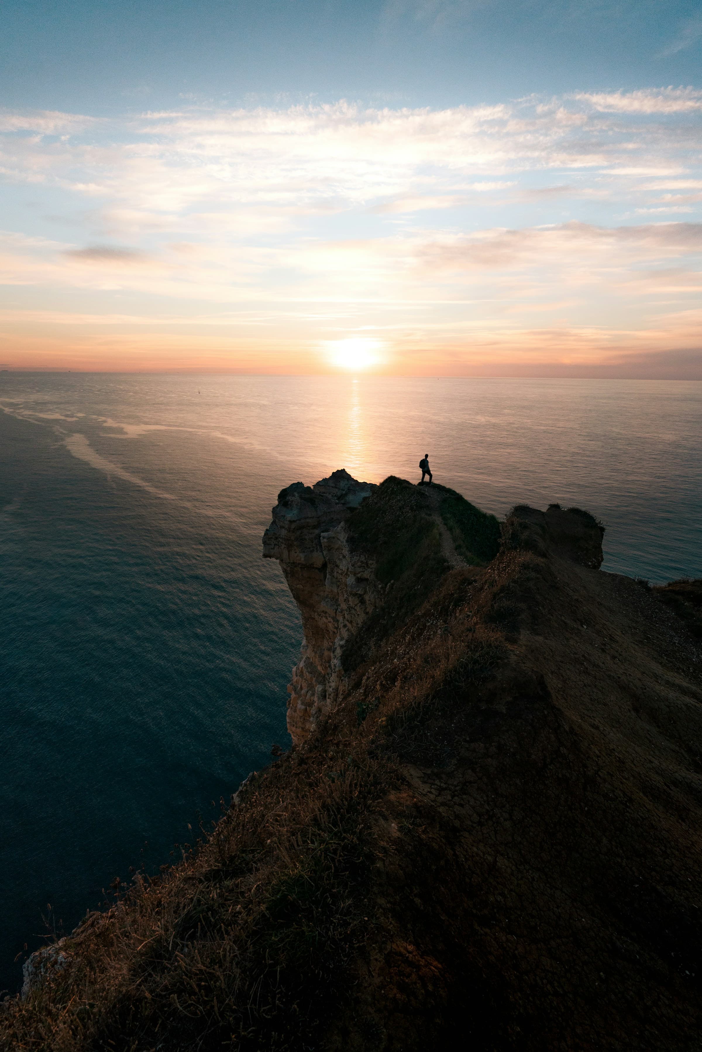 A traveler overlooking a sunlit coastline